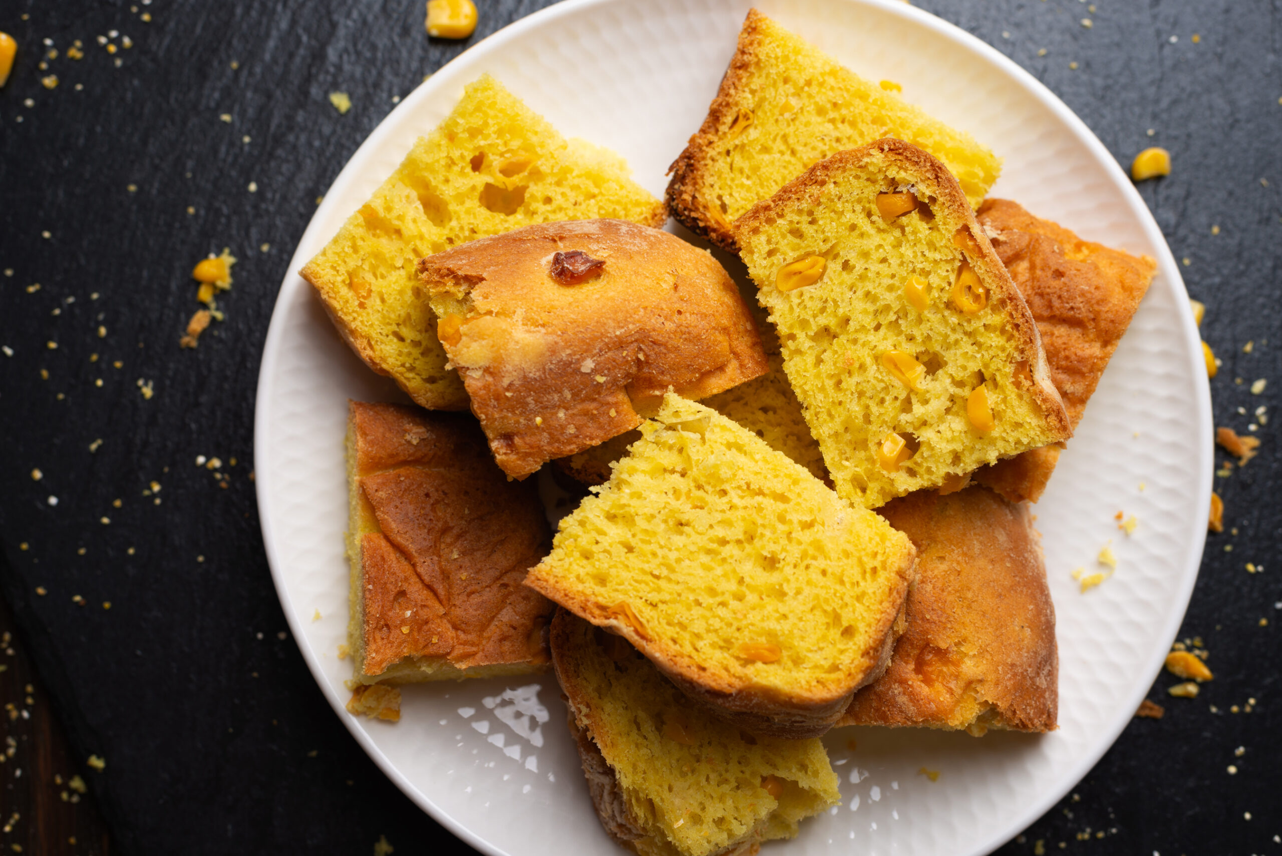 homemade cornbread slices on white dish flat lay v 2023 11 27 04 58 03 utc scaled